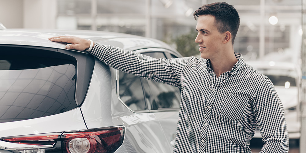 Young_Man_Buying_New_Car_At_The_Dealersh_original_578595
